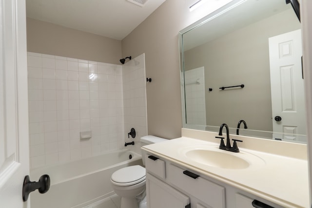 full bathroom with tiled shower / bath, vanity, and toilet