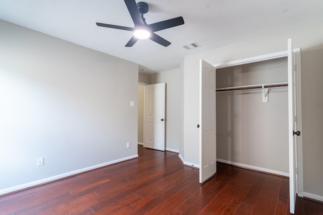 unfurnished bedroom featuring ceiling fan, a closet, and dark hardwood / wood-style flooring