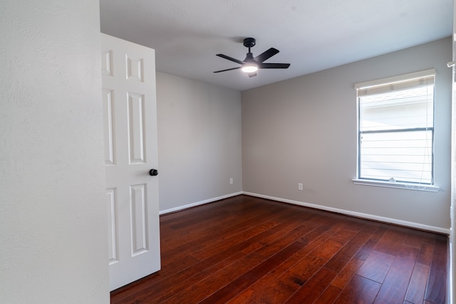 spare room featuring dark hardwood / wood-style floors and ceiling fan