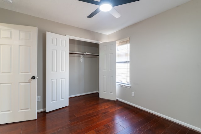 unfurnished bedroom featuring dark hardwood / wood-style floors, ceiling fan, and a closet