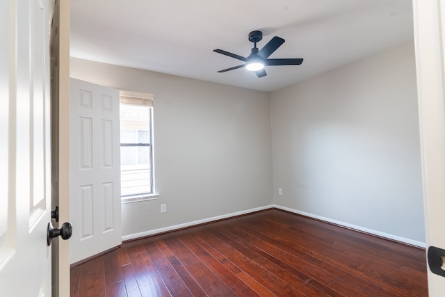 spare room featuring ceiling fan and dark wood-type flooring