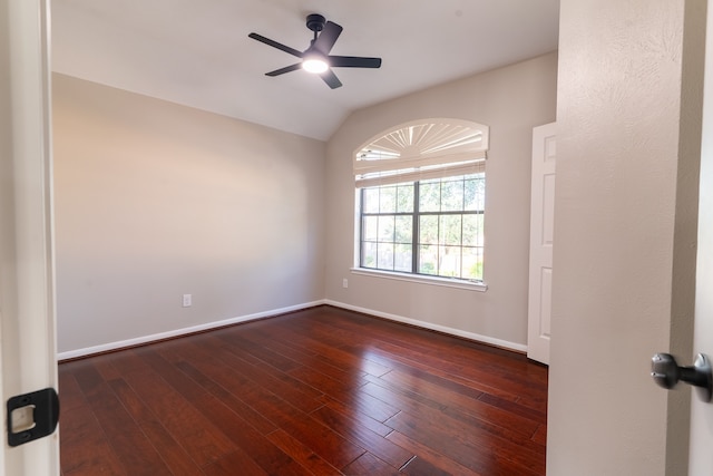 unfurnished room with ceiling fan, lofted ceiling, and dark hardwood / wood-style flooring