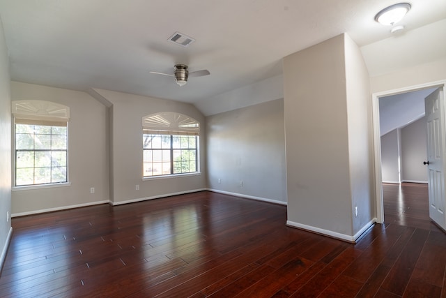 spare room with vaulted ceiling, ceiling fan, and dark hardwood / wood-style flooring