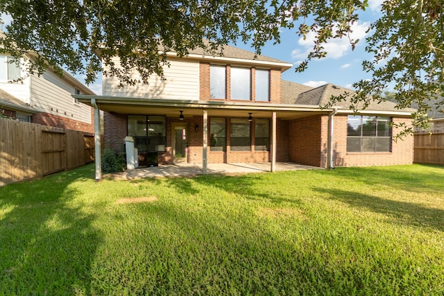 back of house with a patio, ceiling fan, and a yard