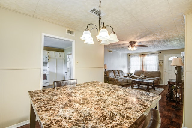 dining space with crown molding and ceiling fan with notable chandelier