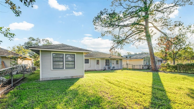 131 Laurel St, Lake Jackson, TX 77566 - back of house featuring a lawn, a fenced backyard, and central air condition unit