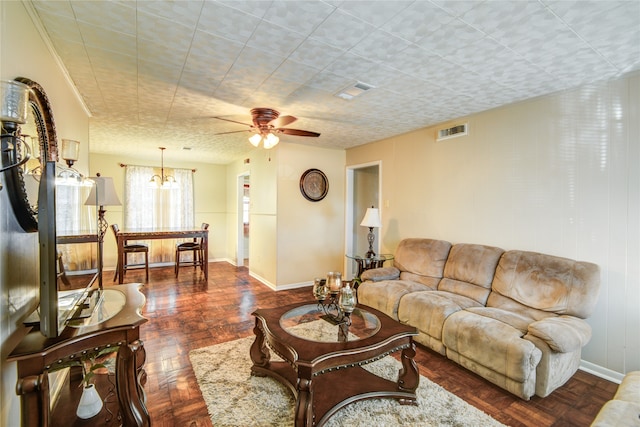 living room featuring ceiling fan with notable chandelier and dark parquet floors