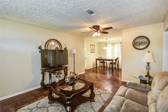 living room with ceiling fan and dark parquet floors