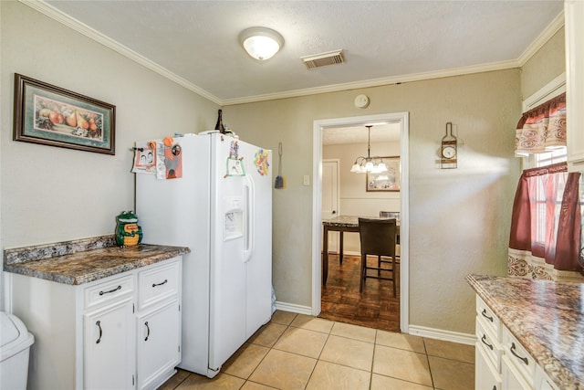 131 Laurel St, Lake Jackson, TX 77566 - kitchen featuring visible vents, crown molding, white refrigerator with ice dispenser, baseboards, and a chandelier