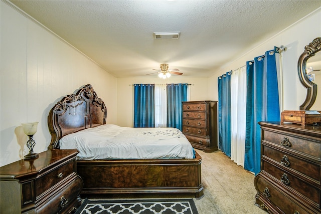 131 Laurel St, Lake Jackson, TX 77566 - carpeted bedroom featuring a ceiling fan, a textured ceiling, and visible vents