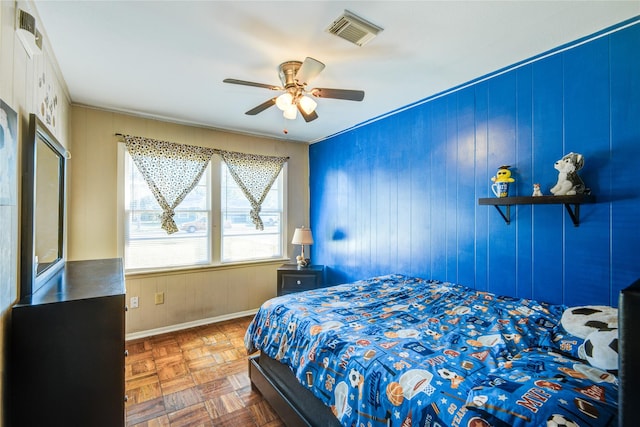 131 Laurel St, Lake Jackson, TX 77566 - bedroom with wood walls, a ceiling fan, baseboards, visible vents, and ornamental molding
