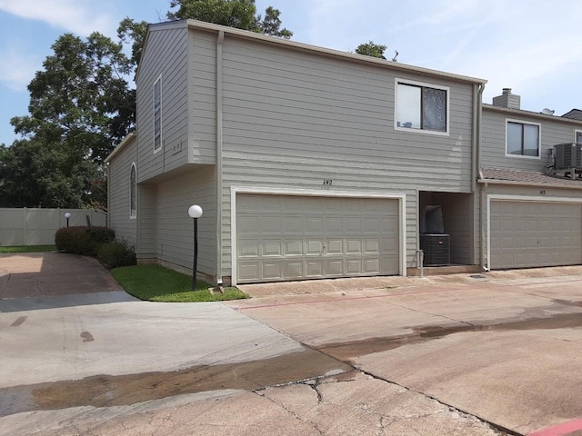 view of front of property with central AC unit and a garage