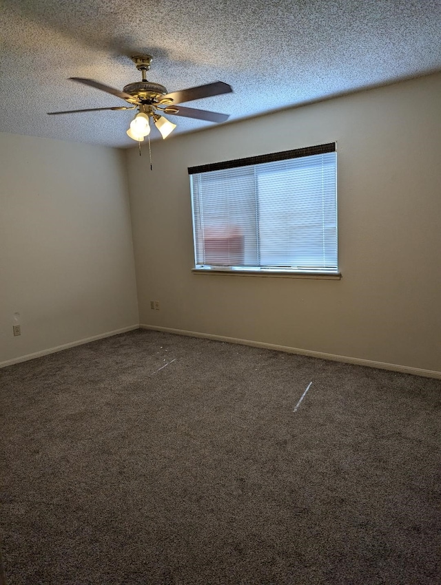 carpeted empty room with ceiling fan and a textured ceiling