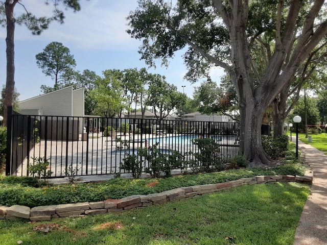 view of pool featuring a yard