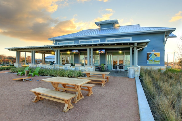 back house at dusk with a patio