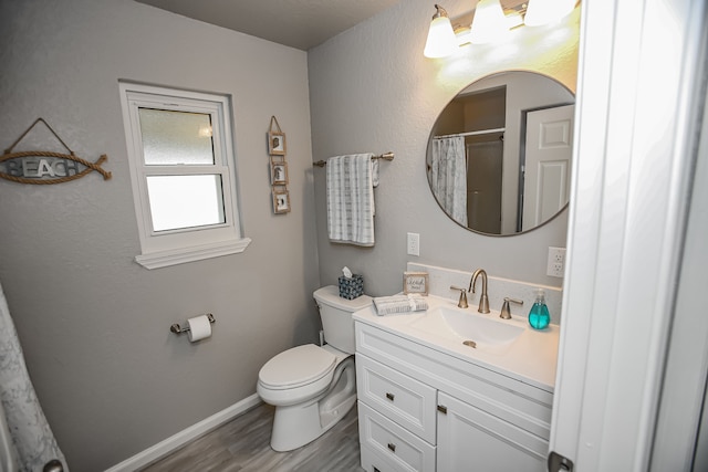 bathroom with vanity, hardwood / wood-style floors, and toilet