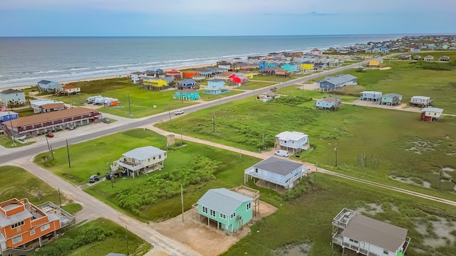 bird's eye view featuring a water view and a beach view