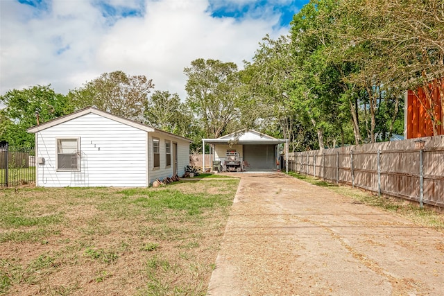 exterior space featuring a lawn and a carport