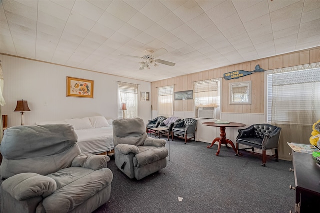 carpeted bedroom featuring ceiling fan, cooling unit, and wood walls