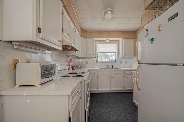 kitchen with light stone counters, sink, white cabinetry, custom exhaust hood, and white appliances