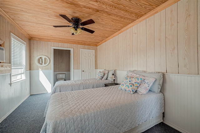 bedroom with ceiling fan, carpet floors, wood ceiling, and wooden walls