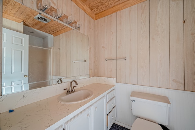 bathroom featuring vanity, wood walls, toilet, and a shower with door