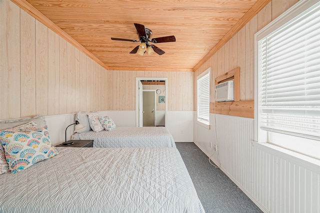 carpeted bedroom featuring wooden ceiling, wood walls, and ceiling fan