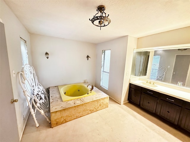 bathroom with a tub and vanity