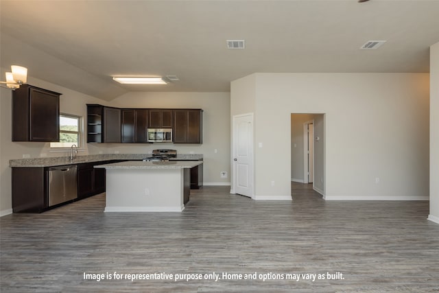 kitchen with wood-type flooring, stainless steel appliances, dark brown cabinetry, and a center island