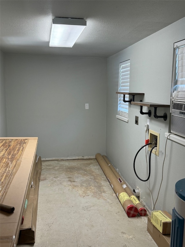 laundry area featuring washer hookup and a textured ceiling