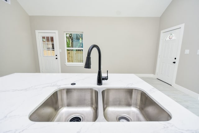 room details with light stone counters and sink