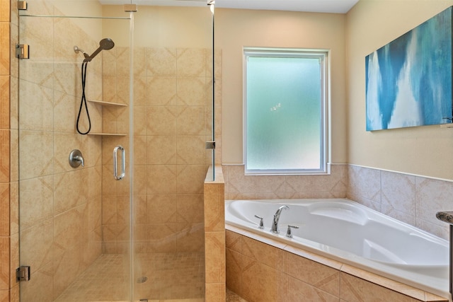 bathroom featuring shower with separate bathtub