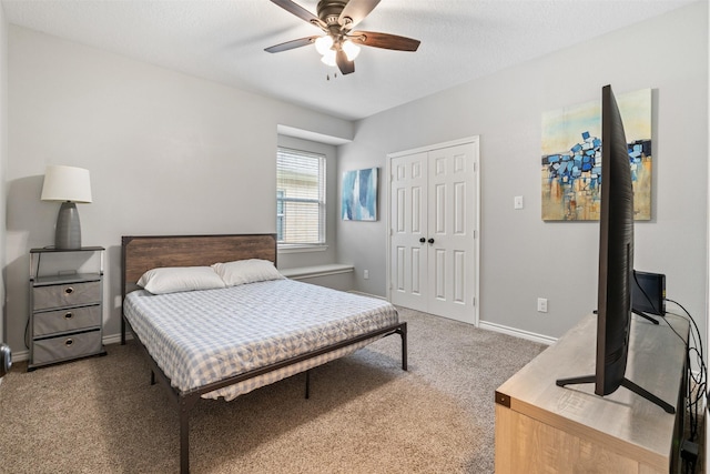 bedroom featuring ceiling fan, a closet, and dark carpet