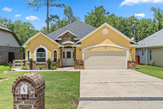 view of front of home featuring a front yard and a garage