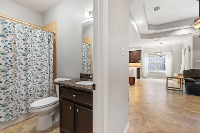 bathroom with toilet, tile patterned floors, vanity, and a notable chandelier