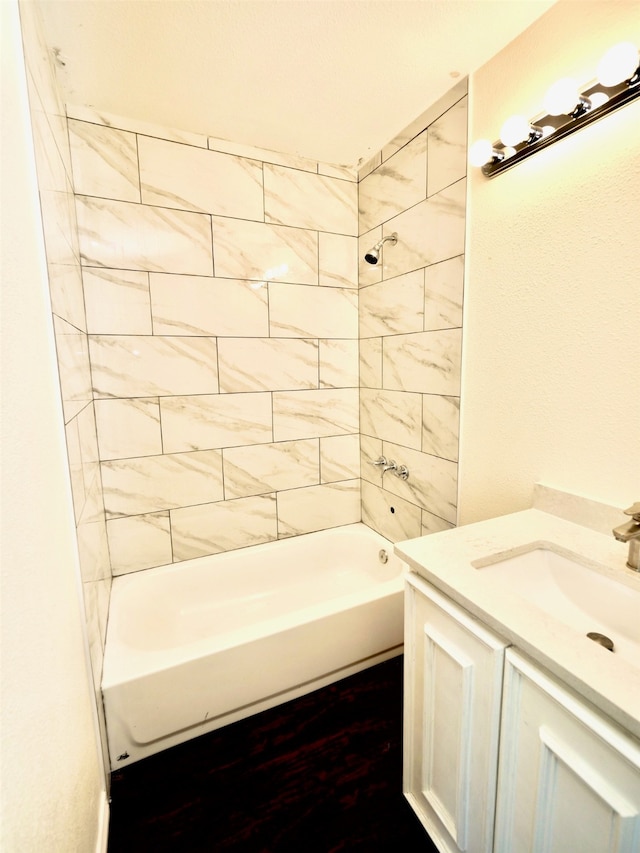 bathroom with vanity and tiled shower / bath combo