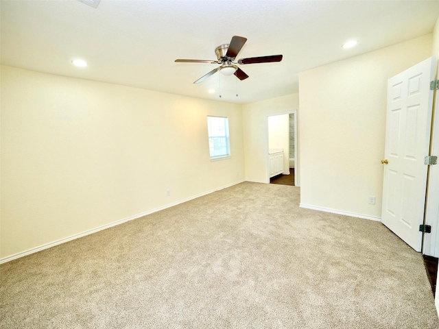 spare room featuring dark colored carpet, a ceiling fan, baseboards, and recessed lighting