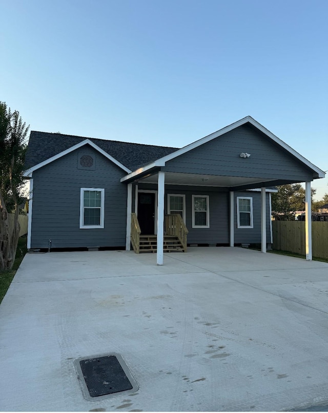 view of front of house with fence and a shingled roof