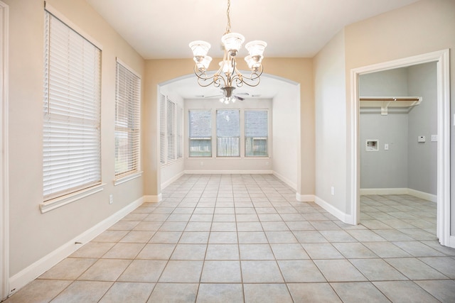 unfurnished dining area featuring an inviting chandelier and light tile patterned flooring