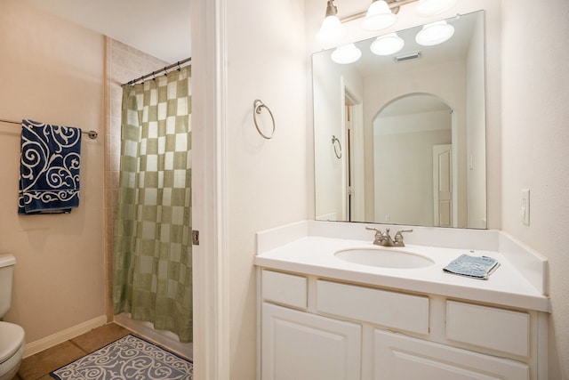 bathroom with a shower with curtain, vanity, tile patterned flooring, and toilet