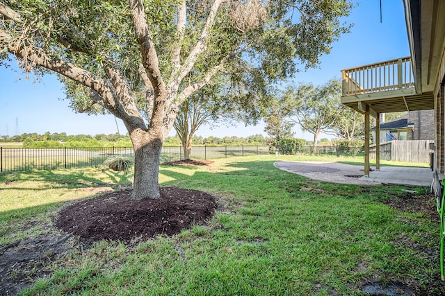 view of yard with a rural view and a patio