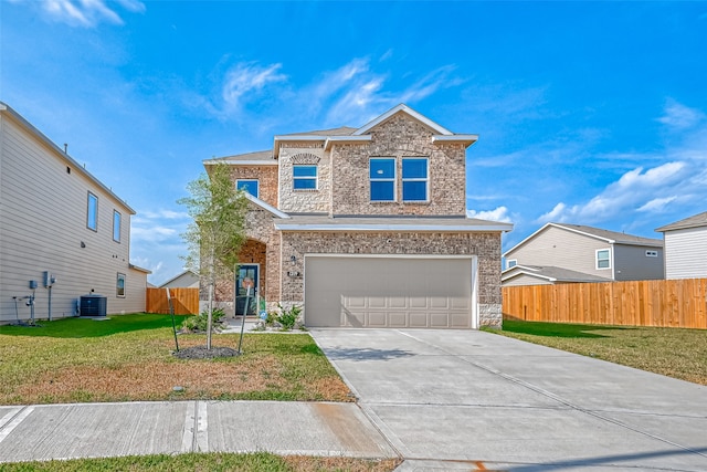 front of property featuring a front yard, cooling unit, and a garage