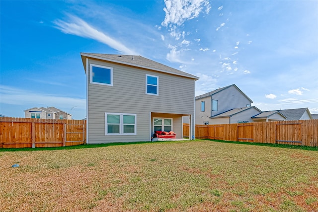 back of property with a lawn and a patio