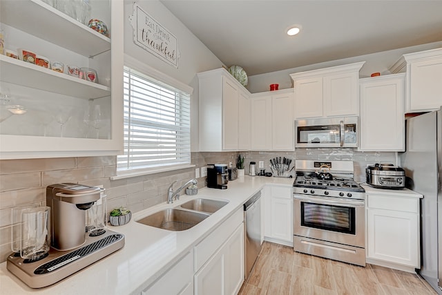 kitchen featuring white cabinets, appliances with stainless steel finishes, and sink