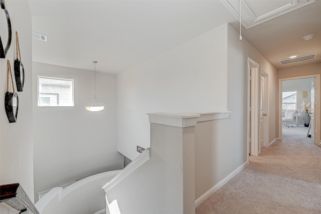 hallway with light colored carpet