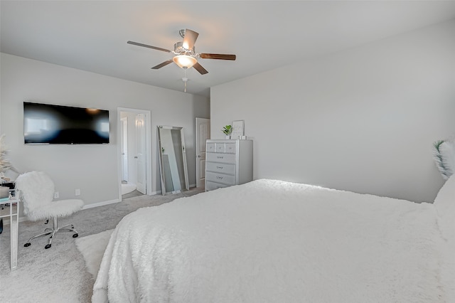 carpeted bedroom with ceiling fan and ensuite bathroom