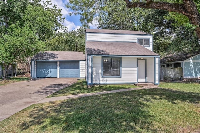 view of front of home with a front yard and a garage