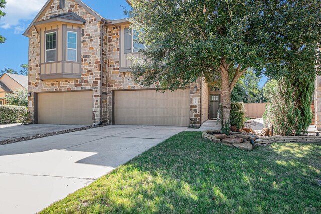 view of front of house with a garage and a front lawn