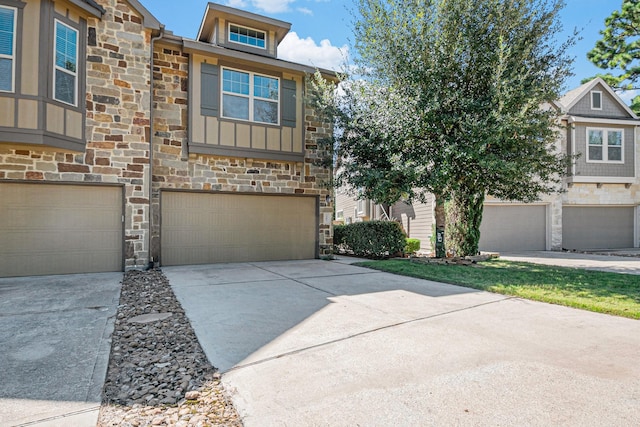 207 Cheswood Forest Pl, Montgomery, TX 77316 - view of front of home with stone siding, driveway, and an attached garage