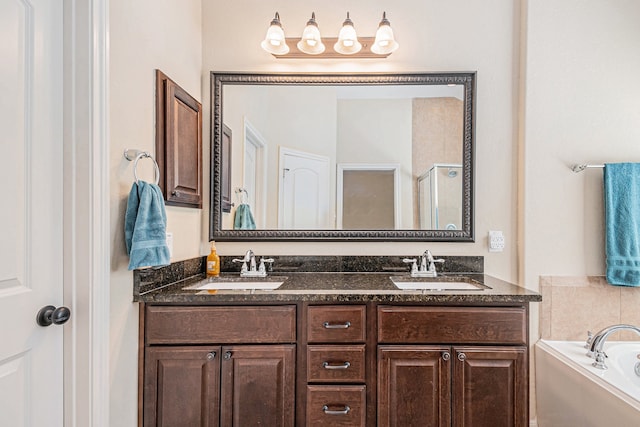 bathroom featuring vanity and independent shower and bath